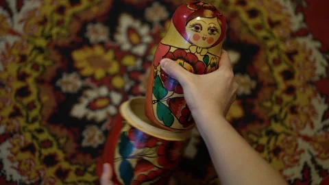 Woman's hands open a painted Russian matryoshka doll Stock Footage 346176885
