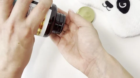 Woman's hands opening a bottle and pouring vitamin pills into her palm on a.. Stock Footage 335141702