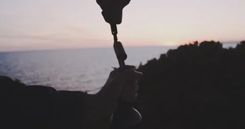 Woman's hands opening a bottle of wine in front of the sunset Stock Footage 203588503