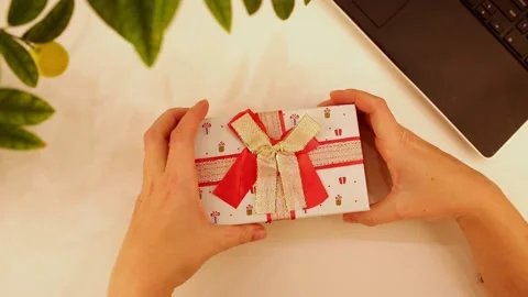Woman's hands opening giftbox from top view Stock Footage 224344446