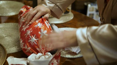Woman's hands opens Christmas gift. Unwrap present Bag. Isolated close-up. Stock-Footage 129686888