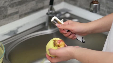 Woman's hands peeling potatoes close up Stock Footage 289388715