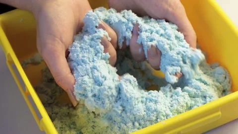 Woman’s hands playing with blue kinetic magic sand Stock Footage 146958018