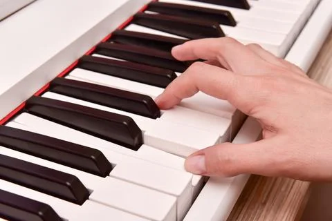 Woman's hands playing electronic digital piano at home. The woman is professi Stock Photos