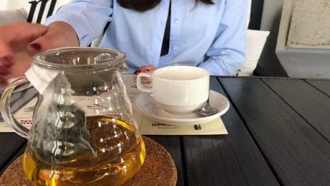 Woman's Hands Pouring a Tea in Cup Stock Footage 98368469