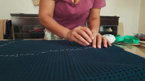 Woman's Hands Precisely Hand Sewing a Seam on Blue Fabric with White Thread Stock Footage 346410224