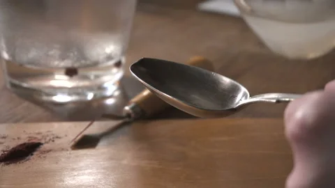 Woman's hands prepare something in the spoon and boil it over the candle flame Stock Footage 89674626