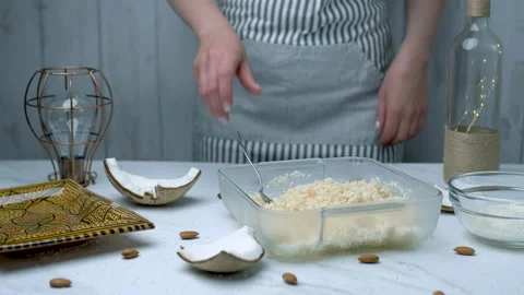 Woman's hands preparing coconut chocolate bowls in 4K Stock Footage 138257792