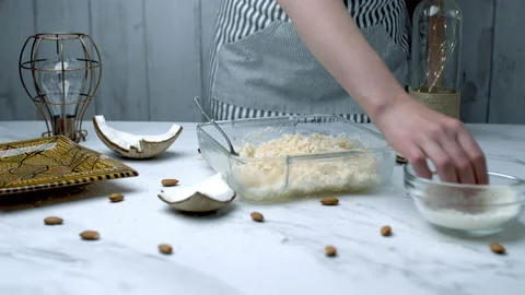 Woman's hands preparing coconut chocolate bowls in 4K Stock Footage 138258232