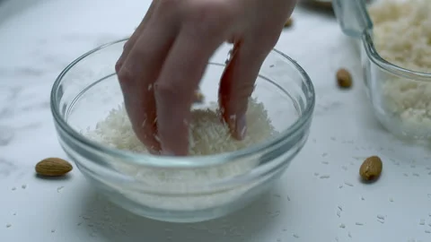 Woman's hands preparing coconut chocolate bowls in 4K Stock Footage 138259255