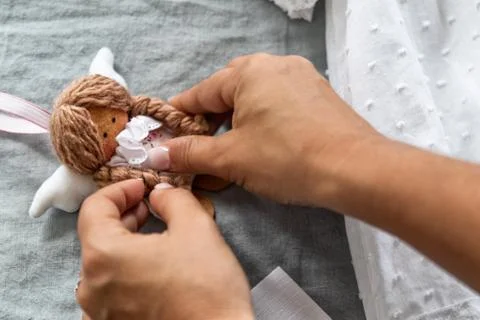 Woman's hands preparing doll. Stock Photos