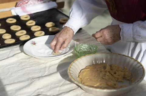 Woman's hands preparing dough to make sweet rolls with typical costumes Stock Photos