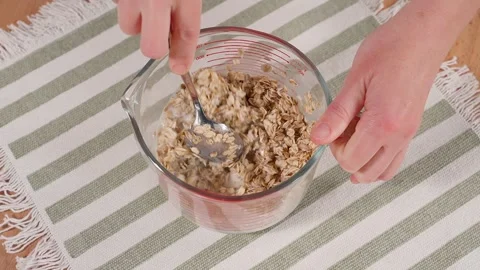 Woman's hands preparing oatmeal Stock Footage 261997786