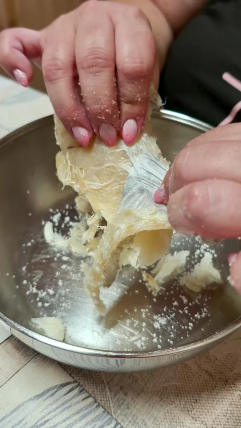 Woman's hands preparing salted cod fish for cooking 動画素材 339322715