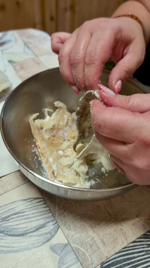 Woman's hands preparing salted cod fish for cooking 動画素材 339322757