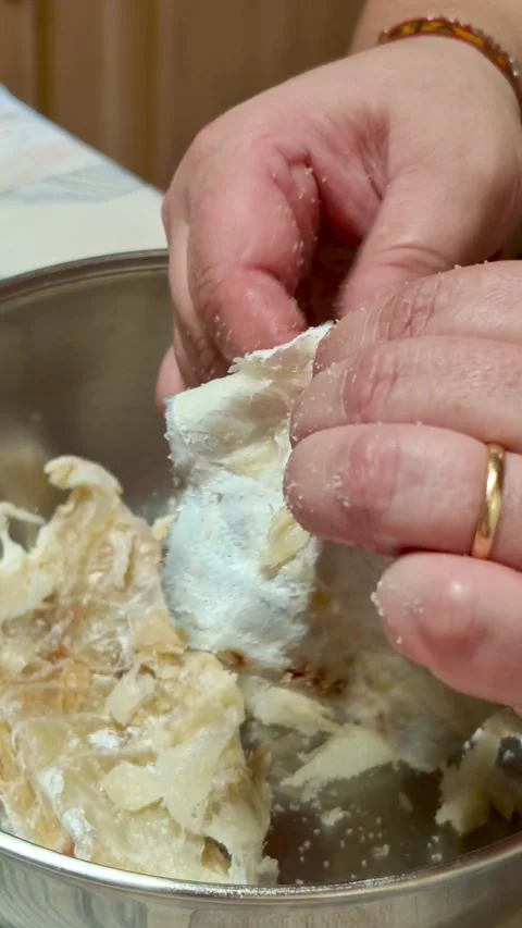 Woman's hands preparing salted cod fish for cooking 動画素材 339322760