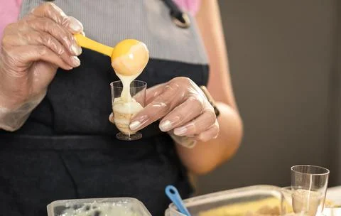 Woman's hands preparing sweet cookie and cream shots Stock Photos