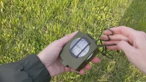Woman's hands pull a compass out of its case Stock Footage 334805934