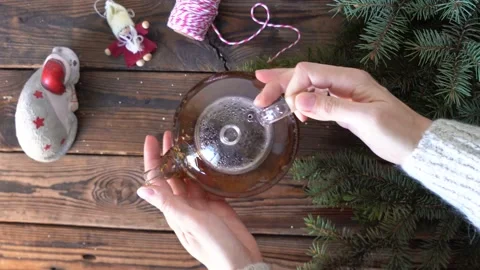 Woman's hands put a pot with hot tea on a wooden table Stock Footage 140808440