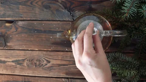 Woman's hands put a pot with hot tea on a wooden table 스톡 동영상 140808488