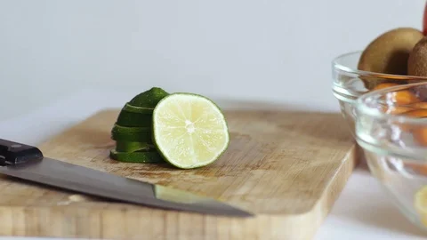 Woman's hands puts lime pyramid in glass plate. Healthly concept Video stock 70964308
