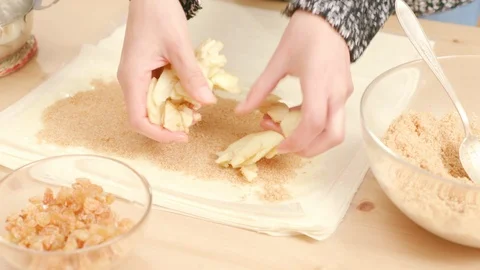 Woman's hands putting apples over phyllo dough to make Viennese strudel Stock Footage 121344484