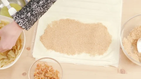 Woman's hands putting apples over phyllo dough to make Viennese strudel Stock Footage 121344571