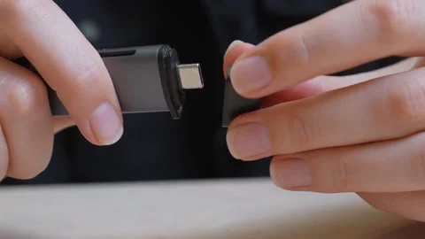 Woman's hands putting cap on usb-c flash drive Stock Footage 323949273