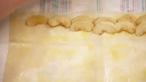Woman's hands putting cut apples to the dough closeup Stock Footage 74463331