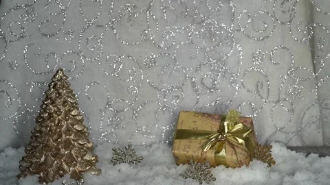 Woman's hands putting on a decoration table with artificial snow two golden and Stock Footage 256016694