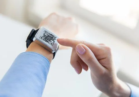 Woman's hands with qr code on smart watch 库存照片