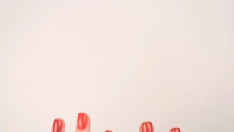 Woman's hands with red manicure appear on white background Stock Footage 106403597
