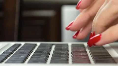 Woman's hands with red manicure typing on computer keyboard. Close-up Vidéo 84757604