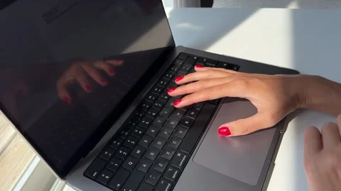 Woman's hands with red manicure typing on a laptop keyboard Stock Footage 342066083