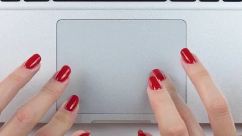 Woman's hands with red manicure using and clicking a portable computer trackpad Vídeos de archivo 84756843