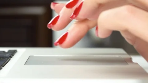 Woman's hands with red manicure using and clicking a portable computer trackpad Vidéo 84756907