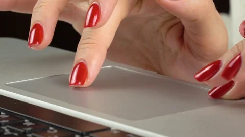 Woman's hands with red manicure using and clicking a portable computer trackpad 스톡 동영상 84757118