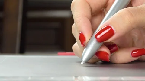 Woman's hands with red manicure using pen tablet. Close-up Stock Footage 84757161