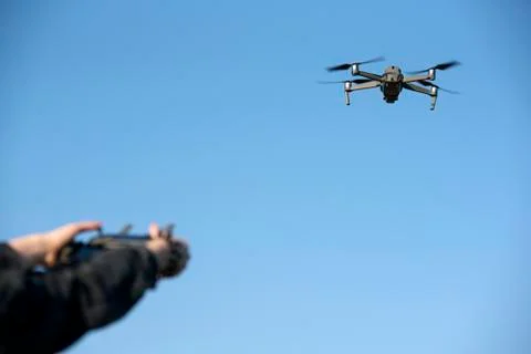 Woman's hands on remote controller that controls the drone. Drone flight Stock Photos