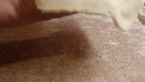 Woman's hands roll piece of puff paste to make delicious cake. Stock Footage 130406220