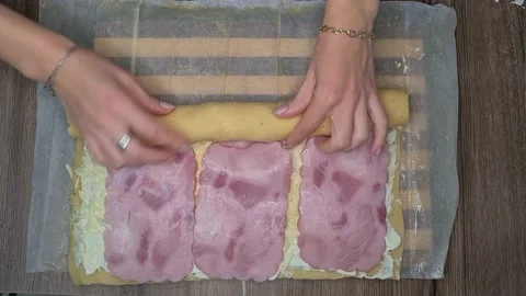 Woman's Hands Rolling Dough With Ham Slices. Ham Bread Roll Video stock 220727309