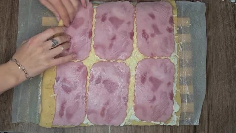 Woman's Hands Rolling Dough With Ham Slices. Ham Bread Roll Video stock 220727310