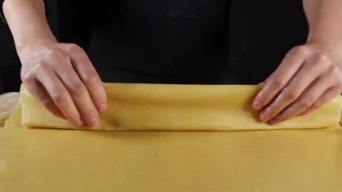 Woman's hands rolling pasta dough into a roll. Stock Footage 219582863