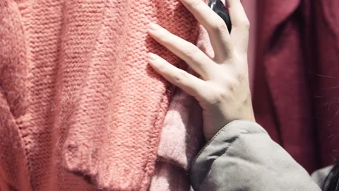 Woman's hands run across a rack of clothes. Sale, shopping, fashion concept. Stock Footage 85695399