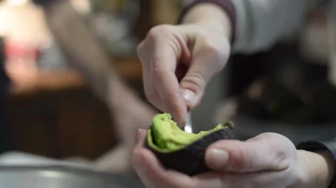 Womans Hands Scooping Avocado 스톡 동영상 66365709