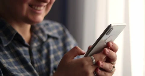 Woman's hands scroll mobile phone keypad to check messages, texting, correspo Stock Footage 301445813