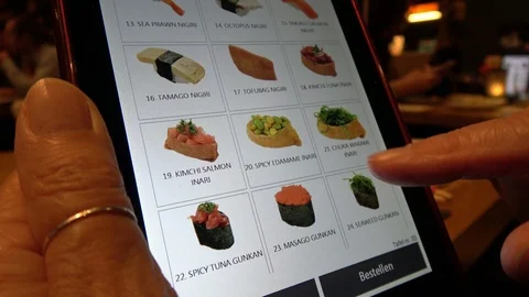 Woman's Hands Scrolling Through Digital Tablet Sushi Menu In A Restaurant Stock Footage 107598913