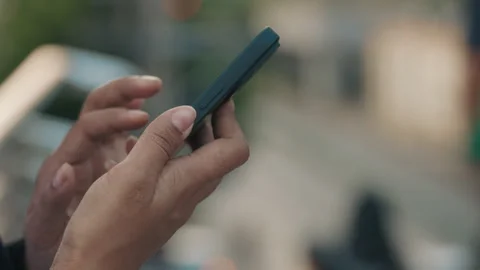 Woman's Hands Scrolling Through Social Media Posts on a Smartphone. Stock Footage 303066338