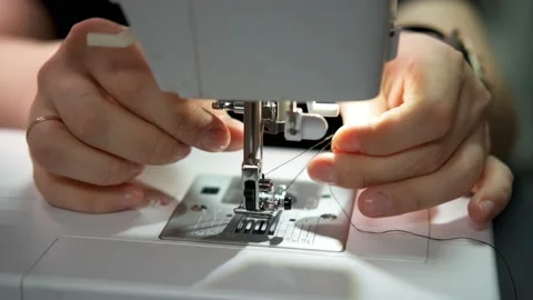 A woman's hands sets the threads in the needle holder. Close up Stock Footage 170369446