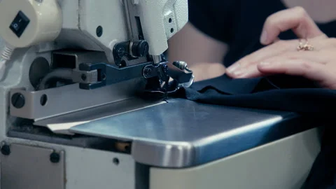 Woman's Hands Sewing Fabric On The Automatic Sewing Machine. Close-Up Seamstress Stock Footage 254373293